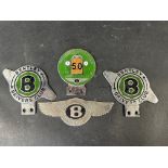 A Bentley Drivers Club Golden Jubilee enamel badge and three other Bentley badges.