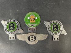A Bentley Drivers Club Golden Jubilee enamel badge and three other Bentley badges.