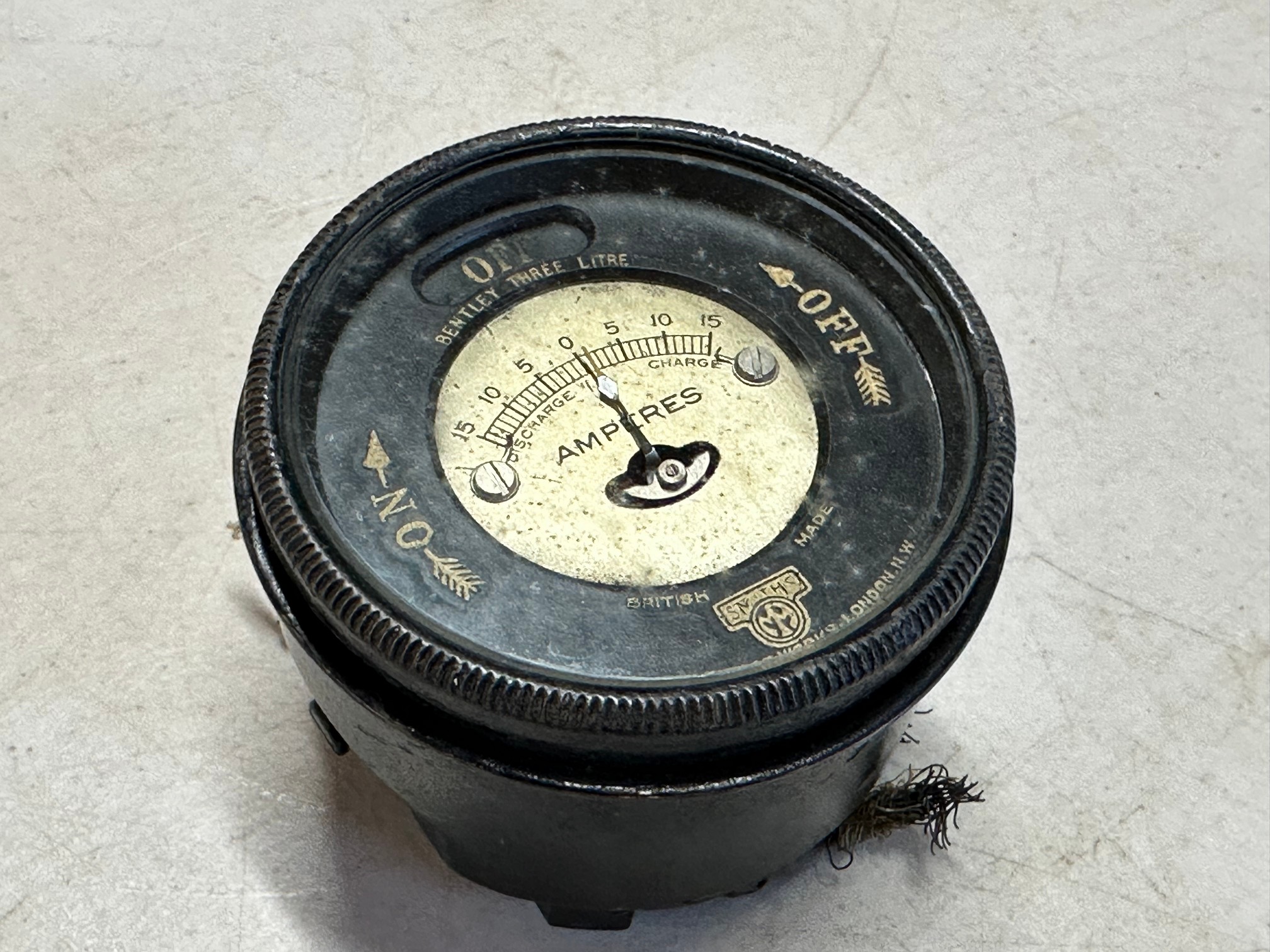 A Smiths bezel ammeter and light switch, to suit Bentley 3-litre.