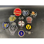 12 assorted car badges.