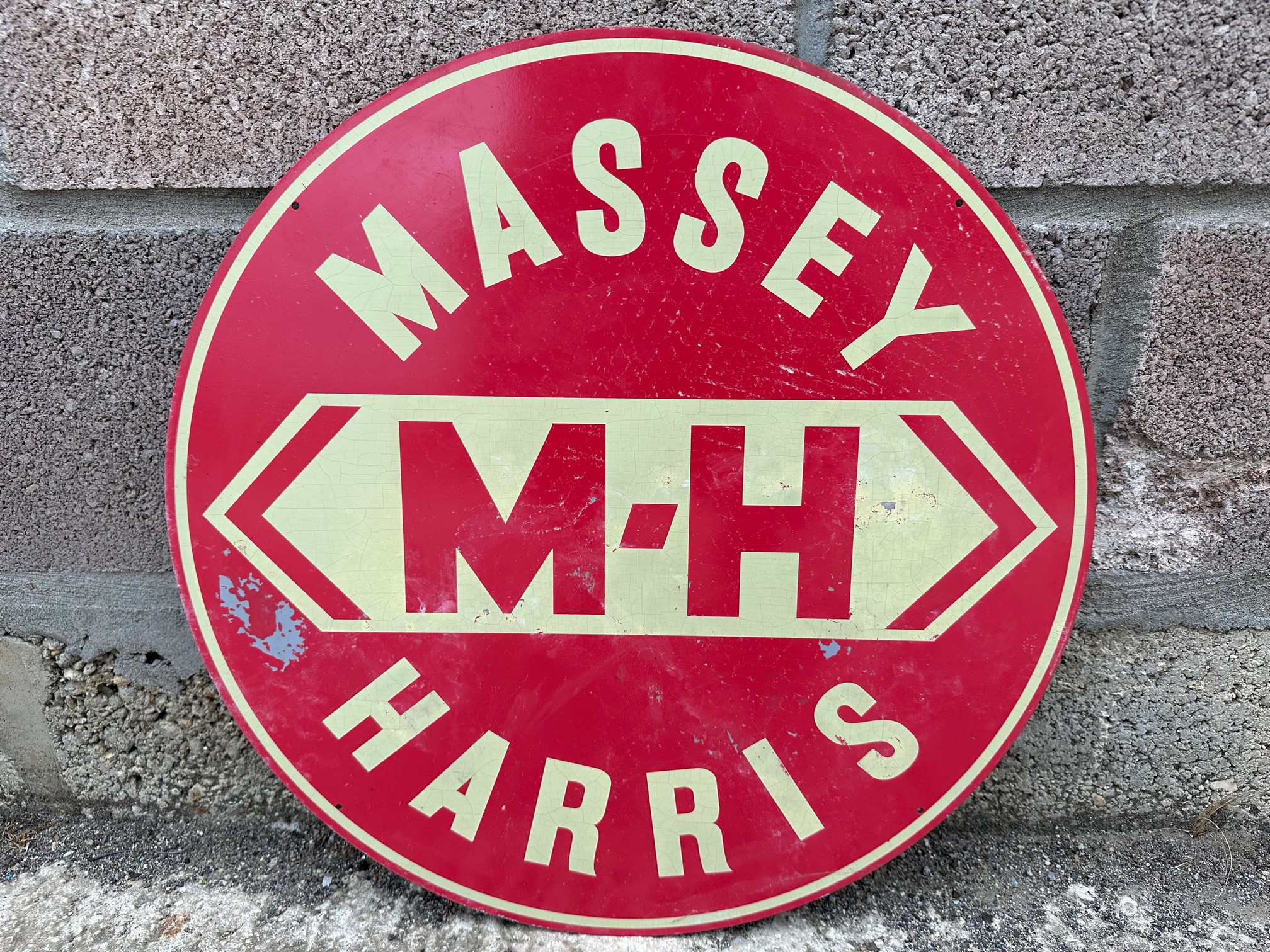 A circular Massey Harris aluminium advertising sign, 21" diameter.