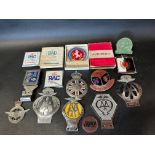 A quantity of assorted car badges.