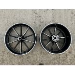 A pair of Harley Davidson wheels, appear either brand new or recently restored.