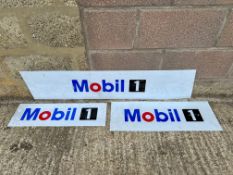 Three plastic Mobil advertising signs.