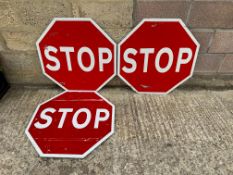 Three modern STOP construction site signs.