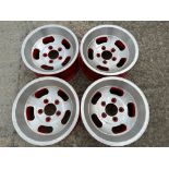 A set of four alloy wheels, 15 1/4" diameter, appear new or refurbished.