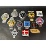 A quantity of assorted car badges.