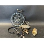 A small selection of bicycle parts and a minature model of a penny farthing.