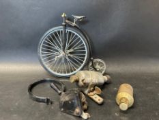 A small selection of bicycle parts and a minature model of a penny farthing.