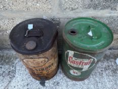 A Wakefield Castrol Motor Oil five gallon oil drum and an Esso Two-Stroke drum.