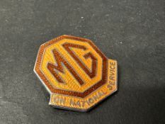 An MG on National Service lapel badge, for factory workers in the factory to wear during war time.