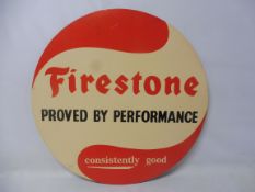 A Firestone Tyres circular cardboard tyre insert sign: Firestone Proved by Performance, consistently