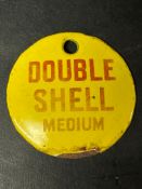 A small circular enamel brand tag for Double Shell Medium, 2 3/4" diameter.