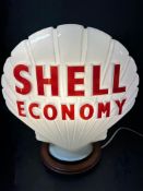 A Shell Economy glass petrol pump globe stamped Hailware with repair and some nibbles to neck.