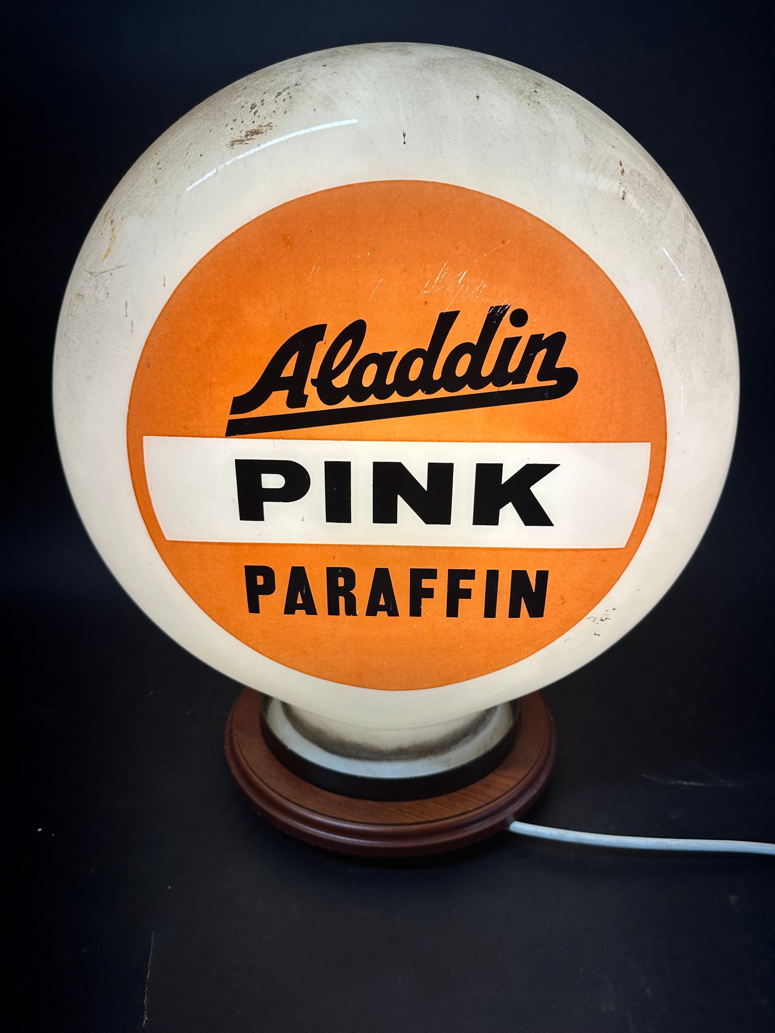 An 'Aladdin Pink Paraffin' pill-shaped fuel pump globe, faintly stamped Hailware to outside,