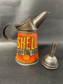 A red Shell Motor Oil quart size oil pourer dated 1930 together with a small funnel.