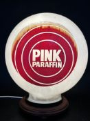 A Pink Paraffin pill-shaped glass petrol pump globe with period decals to one side, made by