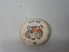 An Esso badge with the slogan 'Put me in'.
