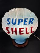 A 'Super Shell' blue glass petrol pump globe, slight chipping to neck under original rubber seal,
