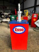 A garage forecourt bulk oil dispensing pump with Esso sticker to front and tag for Regent Oil Co.