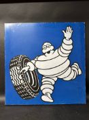 A large Michelin single sided enamel sign depicting Mr Bibendum rolling a tyre ,made in France