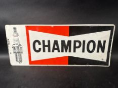 A Champion spark plug pictorial tin advertising sign, made by Milldon Signs Limited. 23 x 9 1/2".