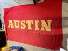 A large double sided canvas flag with appliqued lettering for Austin, 108 x 67 1/2".