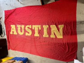 A large double sided canvas flag with appliqued lettering for Austin, 108 x 67 1/2".