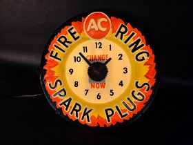 An unusual A.C. Fire Ring Spark Plugs light-up advertising wall clock, 16 1/2" diameter.
