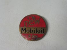 An enamel badge advertising 'The New Mobiloil'.