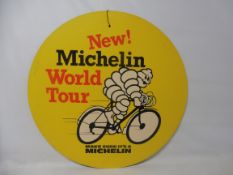 A Michelin Tyres double sided cardboard advertising sign depicting Mr Bibendum riding a bicycle,