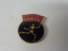 A Lubrication by Shell badge depicting Shell's Robotman aka Stickman.