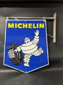 A Michelin Tyres double sided pictorial enamel advertising sign depicting Mr Bibendum rolling a