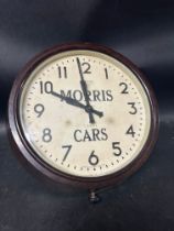 A Smiths eightday dealer's garage wall clock advertising Morris Cars, in bakelite frame, crack to