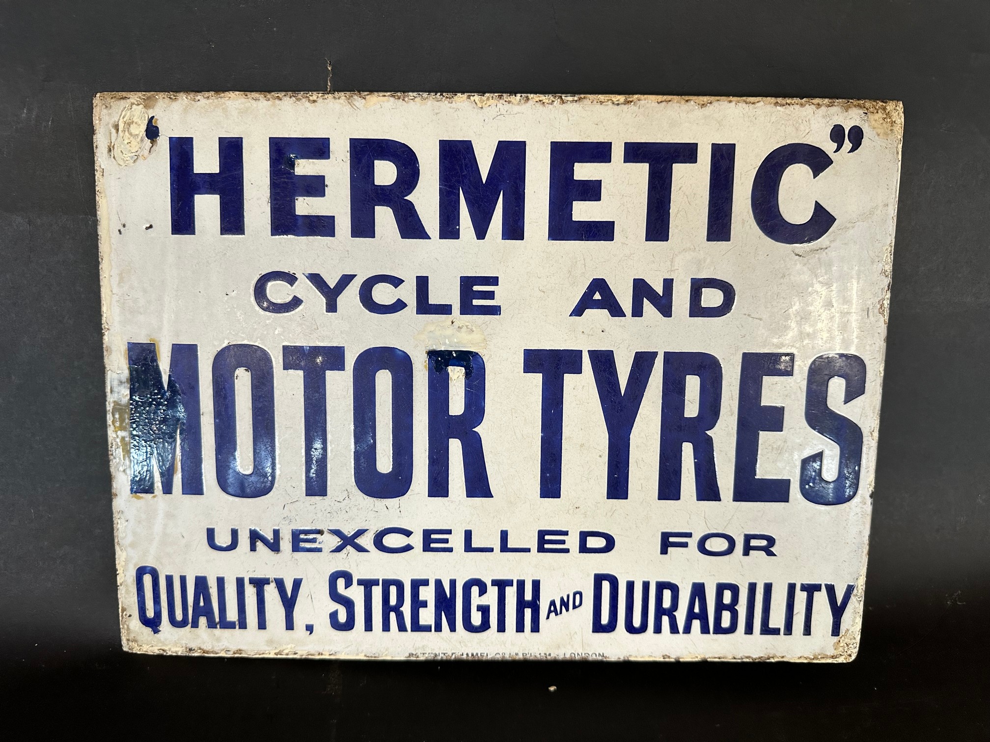 A Hermetic Cycle and Motor Tyres double sided enamel advertising sign with hanging flange in