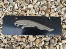 A Jaguar leaping cat alloy sign on tin backing, 12 x 4".