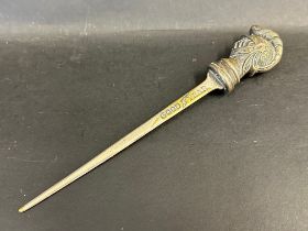A Goodyear branded letter opener surmounted by the head of a knight.
