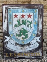 A pair of painted aluminium signs mounted back to back, advertising the Hampshire village of