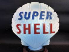 A blue Super Shell glass petrol pump globe by Hailware, damage to neck.