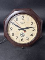 A Smiths Sectric dealer garage wall clock in octagonal bakelite frame with applied paper MG logo.