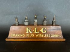 A K.L.G Sparking Plug Wireless Screens countertop advertising display stand, with mounted spark