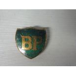 A BP shield shaped badge by J.R. Gaunt, London.