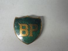 A BP shield shaped badge by J.R. Gaunt, London.