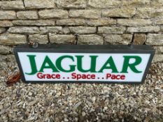 A contemporary Jaguar light up sign with green lettering on white panel, 39 3/4 x 13 3/4".