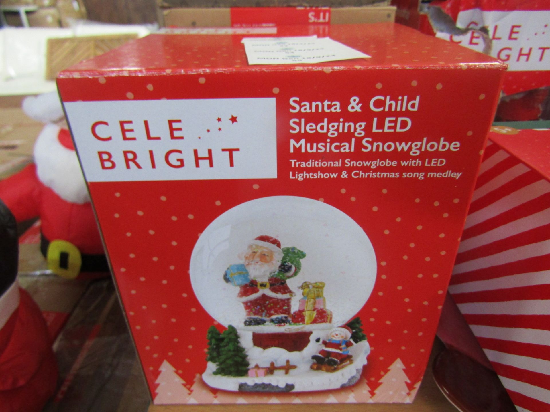 Celebright - Santa & Child Sledging LED Musical Snowglobe - Looks In Good Condition & Boxed.