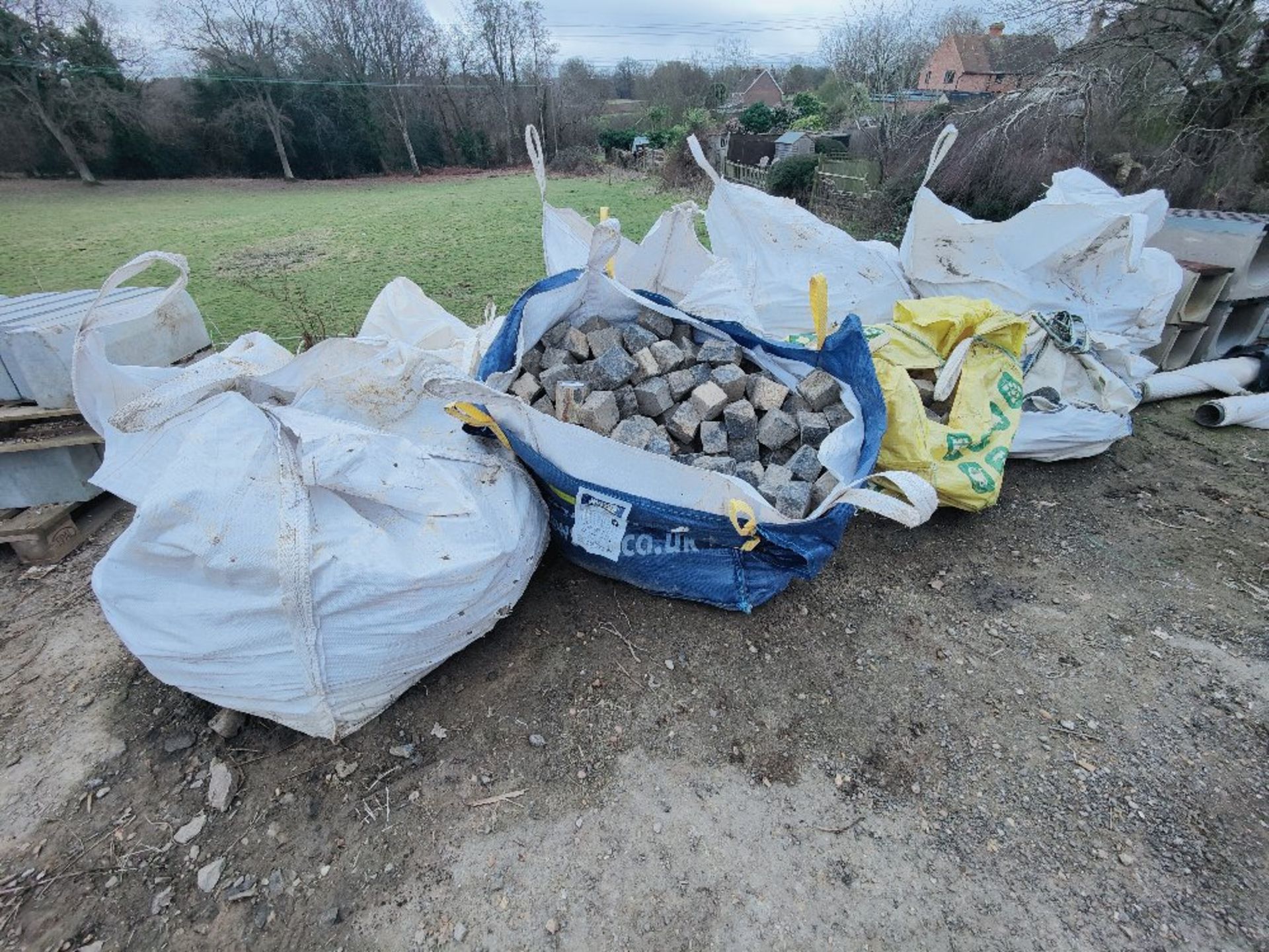 (11) bags of partially used bags of paving blocks