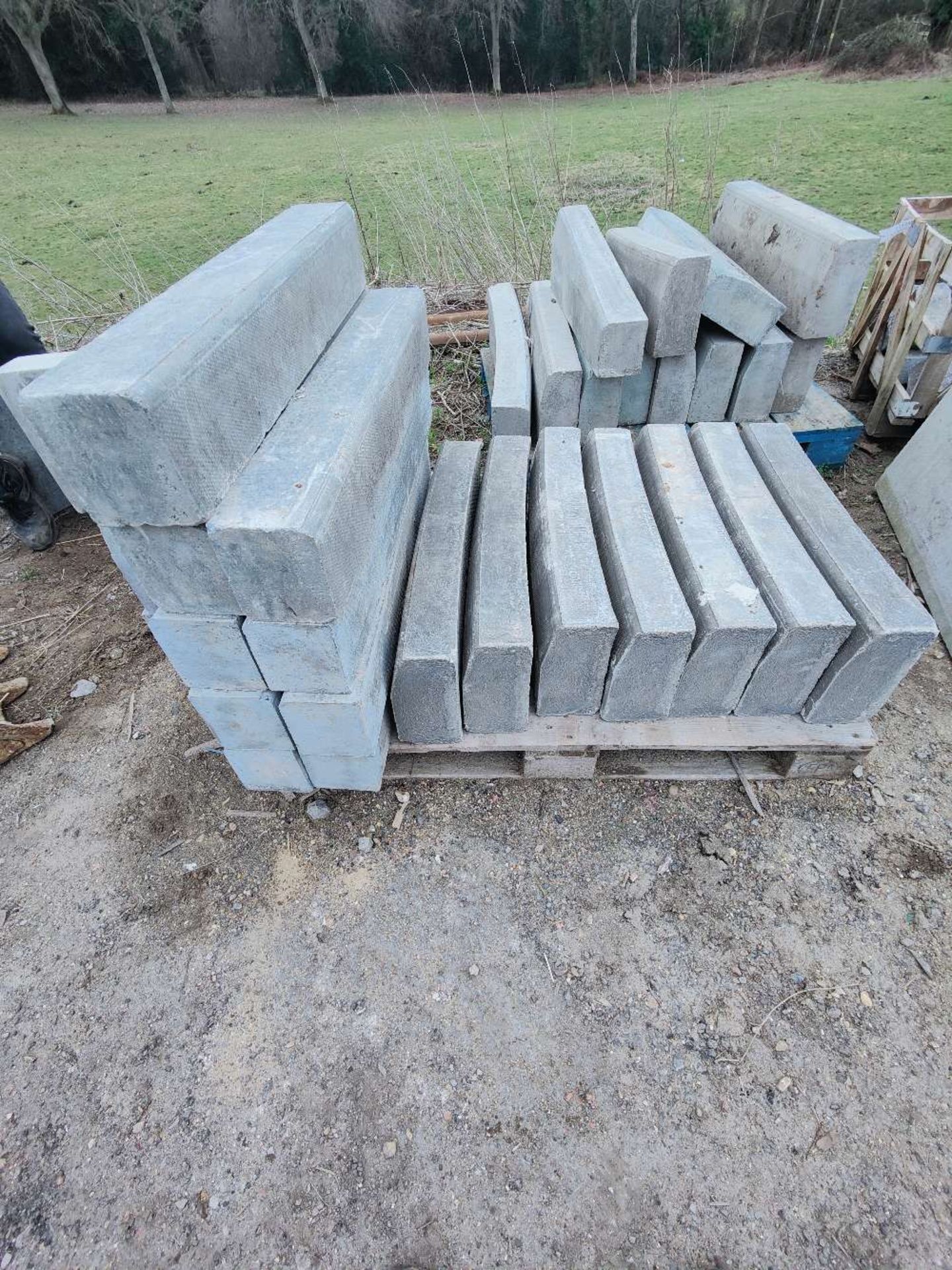 Quantity of various kerb stones, corner blocks and curved blocks, as lotted