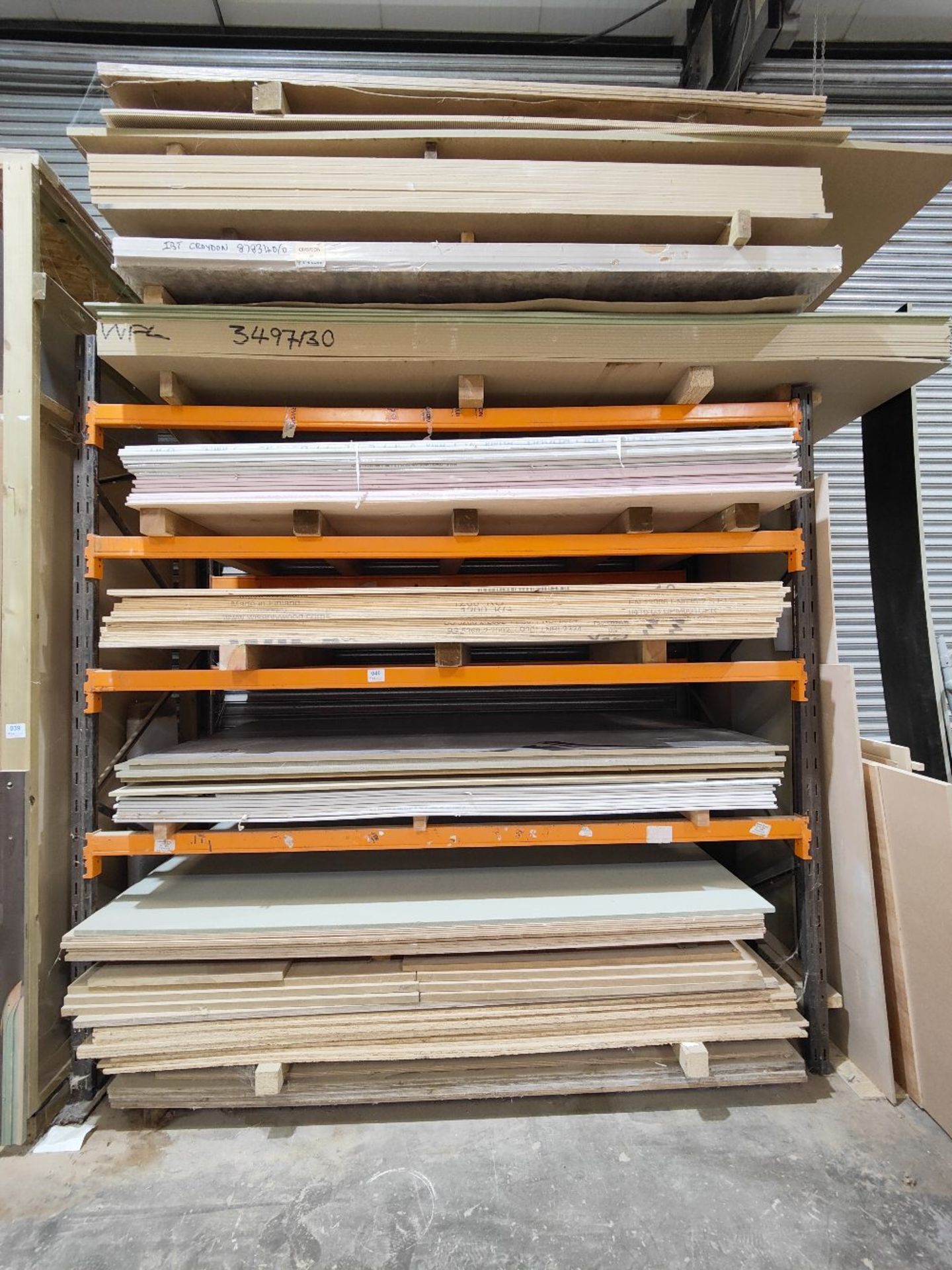 Large quantity of sheet timber stock in racking to include: