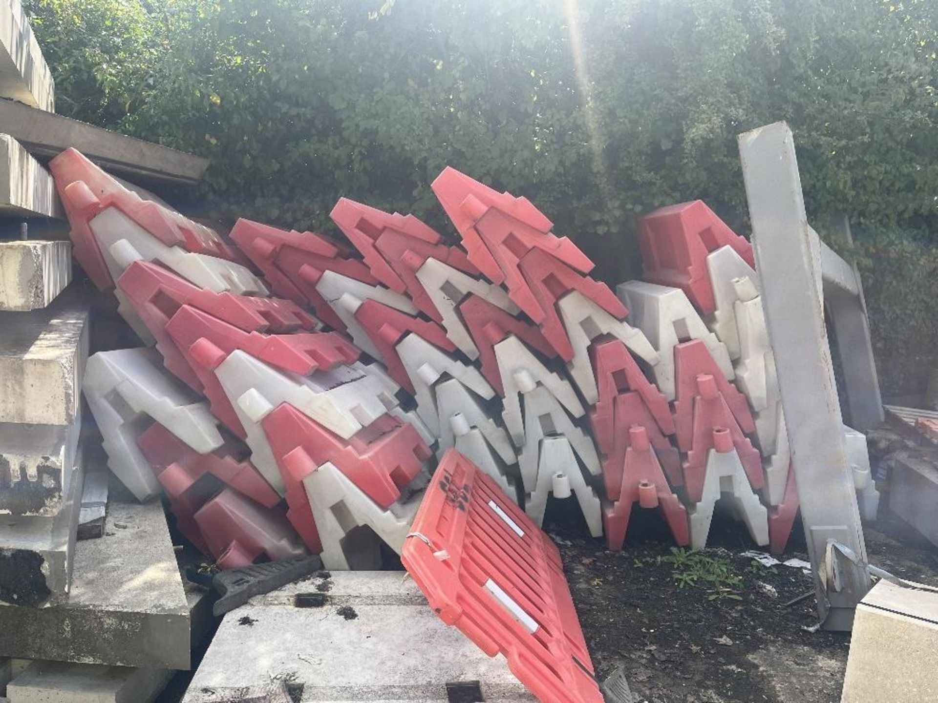 Approximately 100 red and white pedestrian barricades