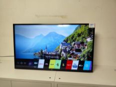 LG 43UM7450PLA television with remote control and power cord